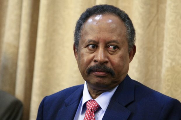 (FILES) In this file photo taken on August 21, 2019 Abdallah Hamdok looks on after being sworn in as Sudan's interim prime minister in the capital Khartoum. - Sudan's Prime Minister Abdalla Hamdok, the face of the country's fragile transition to civilian rule for more than two years before he was ousted and detained in an October coup then reinstated last month, resigned today in another blow to the turbulent African nation. (Photo by Ebrahim HAMID / AFP)