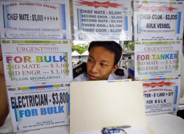 An employee of a Philippine staffing agency for seafarers mans the recruiting booth at a seafarer's park in Manila on October 24. The Philippines supplies a third of the worlds merchant mariners, whose remittances help to buoy the economy amids the global credit crisis. Analysts say, the seafarers will hardly feel the pinch, with Filipino seamen consierec among the world's best.     AFP PHOTO/LUIS LIWANAG (Photo by LUIS LIWANAG / AFP); overseas Filipino