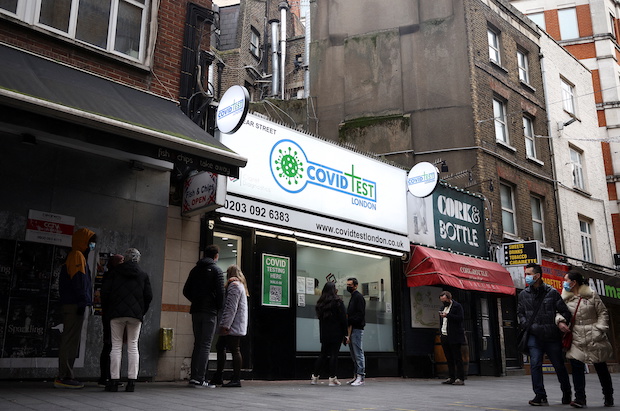 People queue outside a private coronavirus disease (COVID-19) testing facility, amid the COVID-19 outbreak, in central London