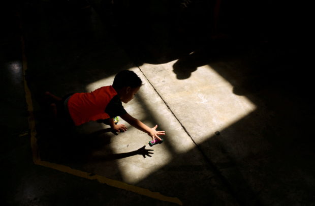 A migrant boy, who returned to Mexico with his parents from the U.S. under the Migrant Protection Protocols (MPP) to wait for their court hearing for asylum seekers, plays at a migrant shelter run by the federal government in Ciudad Juarez, Mexico September 26, 2019. REUTERS/Jose Luis Gonzalez/File Photo