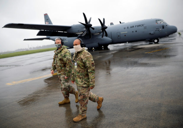 FILE PHOTO: U.S. soldiers wearing protective face masks are seen in front of C-130 transport planes during a military drill amid the coronavirus disease (COVID-19) outbreak, at Yokota U.S. Air Force Base in Fussa, on the outskirts of Tokyo, Japan May 21, 2020.  REUTERS/Issei Kato