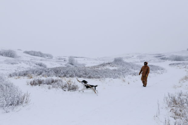 Dale Erickson walks his dog in Nose Hill Park during an Extreme Cold Warning and wind chill of -35 Celsius (-31 F) in Calgary, Alberta, Canada, January 3, 2022. Picture taken January 3, 2022.  REUTERS/Valerie Zink