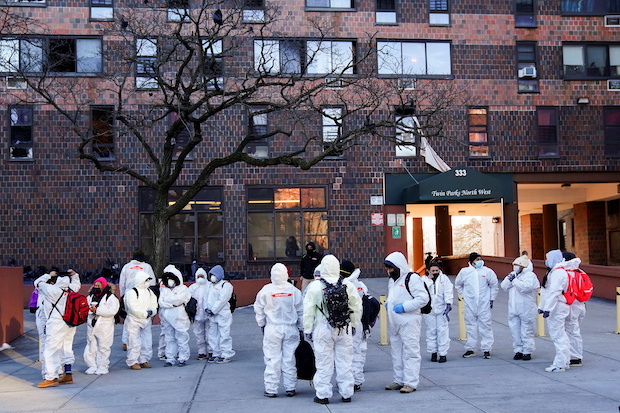 Workers clean up at the scene of a fire at an apartment building in New York City