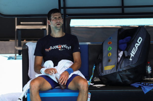 Serbian tennis player Novak Djokovic rests at Melbourne Park as questions remain over the legal battle regarding his visa to play in the Australian Open in Melbourne, Australia, January 12, 2022.  REUTERS/Loren Elliott