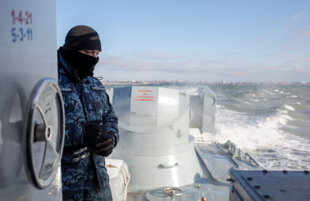 FILE PHOTO: A Ukrainian navy sailor is seen on board an armoured gunboat during a short voyage near a base of the Ukrainian Naval Forces in the Azov Sea port of Berdyansk, Ukraine January 12, 2022. REUTERS/Anastasia Vlasova