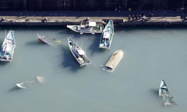 An aerial view shows capsized boats believed to be affected by the tsunami caused by an underwater volcano eruption on the island of Tonga at the South Pacific, in Muroto, Kochi prefecture, Japan, in this photo taken by Kyodo January 16, 2022. Mandatory credit Kyodo/via REUTERS