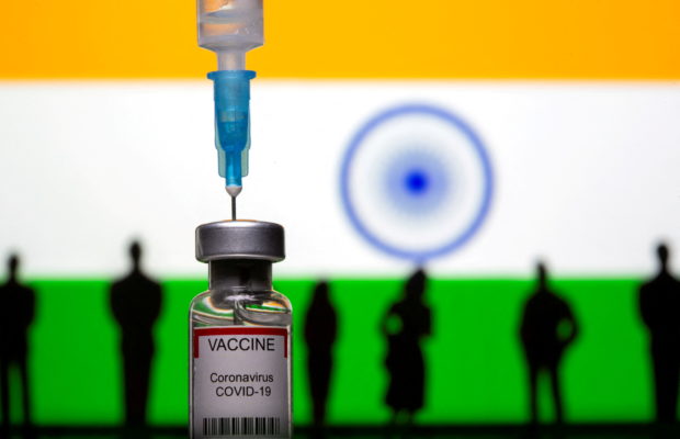 FILE PHOTO: 3D-printed small toy figurines, a syringe and vial labelled "coronavirus disease (COVID-19) vaccine" are seen in front of India flag in this illustration taken May 4, 2021. REUTERS/Dado Ruvic/Illustration/File Photo