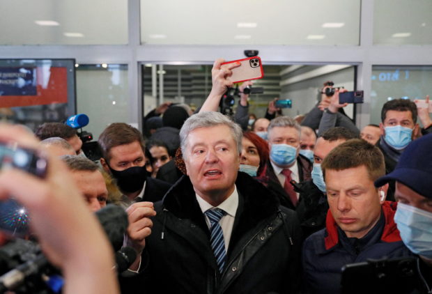 Ukrainian former President Petro Poroshenko speaks to journalists upon arrival at Zhulyany airport in Kyiv, Ukraine January 17, 2022. REUTERS/Gleb Garanich