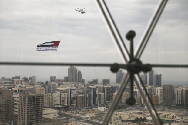 FILE PHOTO: A helicopter flies over the downtown skyline, amid the coronavirus disease (COVID-19) outbreak, as seen from the Cleveland Clinic hospital in Abu Dhabi, United Arab Emirates, April 20, 2020. REUTERS/Christopher Pike