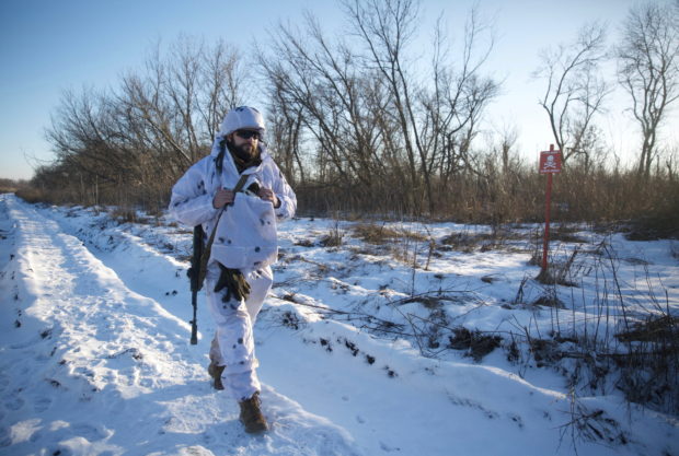 A service member of the Ukrainian armed forces walks at combat positions near the line of separation from Russian-backed rebels near Horlivka in the Donetsk region, Ukraine, January 20, 2022. Picture taken January 20, 2022. REUTERS/Anna Kudriavtseva