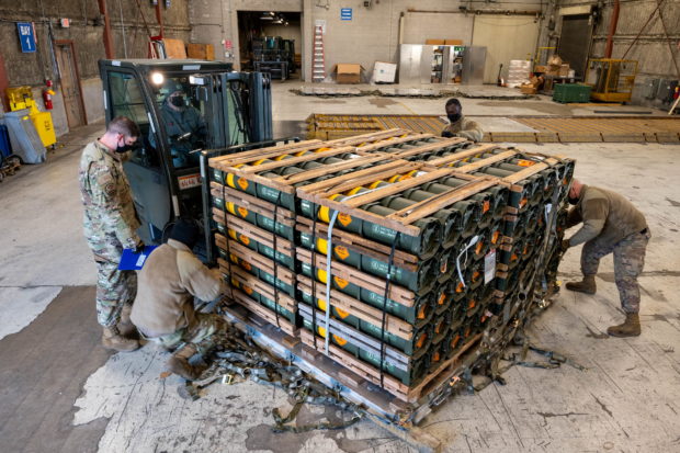 Airmen and civilians from the 436th Aerial Port Squadron palletize ammunition, weapons and other equipment bound for Ukraine during a foreign military sales mission at Dover Air Force Base, in Delaware, U.S. January 21, 2022. U.S. Air Force/Mauricio Campino/Handout via REUTERS