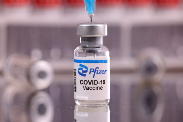 FILE PHOTO: A vial labelled "Pfizer COVID-19 Vaccine" is seen in this illustration taken January 16, 2022. REUTERS/Dado Ruvic/Illustration