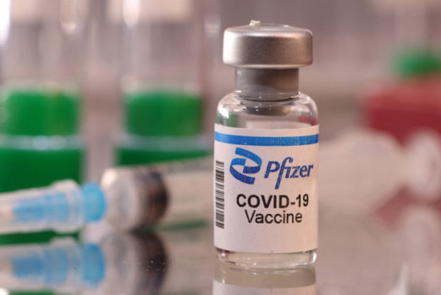 FILE PHOTO: A vial labelled "Pfizer COVID-19 Vaccine" is seen in this illustration taken January 16, 2022. REUTERS/Dado Ruvic