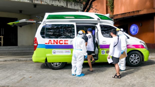 A patient suspected of having COVID-19 was brought to an ambulance amid another wave of coronavirus in Metro Manila. Image from OVP / Facebook; ambulance, PPE, Swab Cab