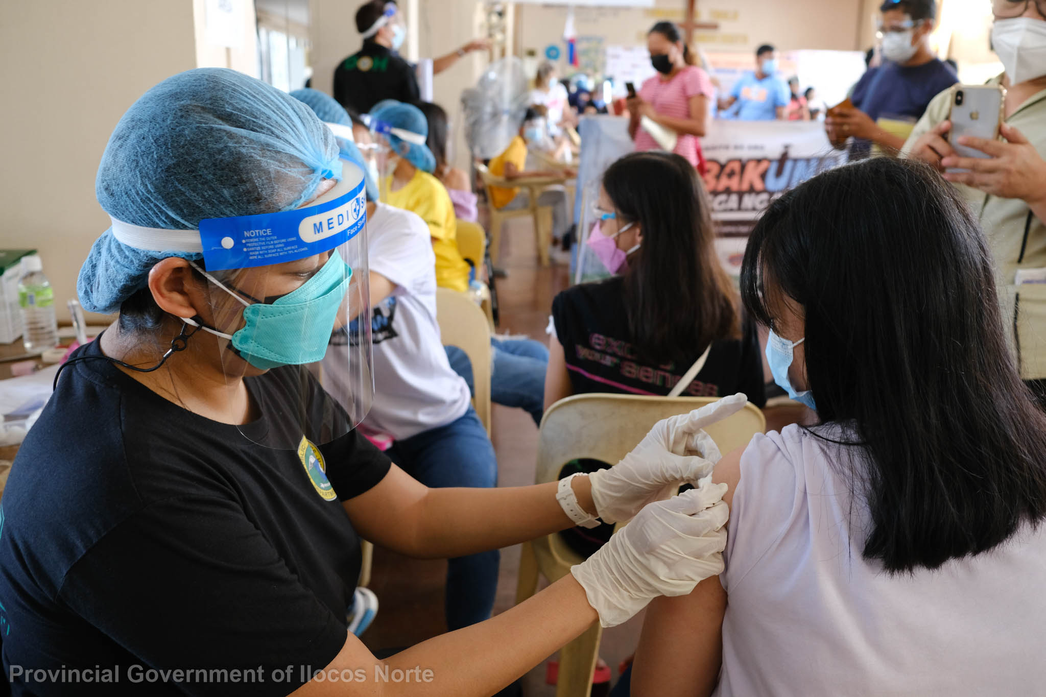 Minors receive COVID-19 vaccines at a facility in Ilocos Norte province