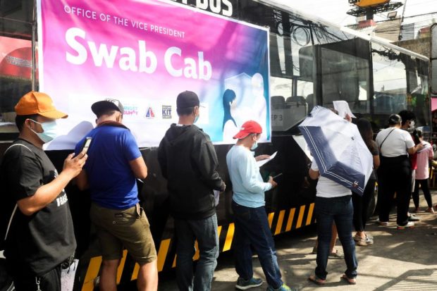 People lining up at a Swab Cab from the Office of the Vice President