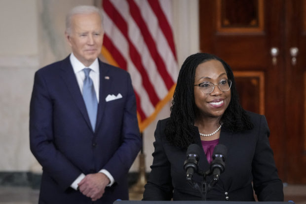 WASHINGTON, DC - FEBRUARY 25: U.S. President Joe Biden (L) looks on as Ketanji Brown Jackson, circuit judge on the U.S. Court of Appeals for the District of Columbia Circuit, delivers brief remarks as his nominee to the U.S. Supreme Court during an event in the Cross Hall of the White House February 25, 2022 in Washington, DC. Pending confirmation, Judge Brown Jackson would succeed retiring Associate Justice Stephen Breyer and become the first-ever Black woman to serve on the high court.   Drew Angerer/Getty Images/AFP (Photo by Drew Angerer / GETTY IMAGES NORTH AMERICA / Getty Images via AFP)