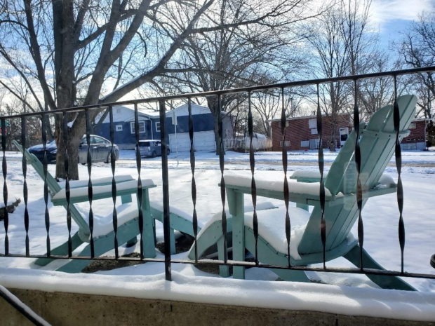 Snow blankets outdoor furniture in Lawrence, Kansas, U.S. February 3, 2022. Tess Jehle/Handout via REUTERS