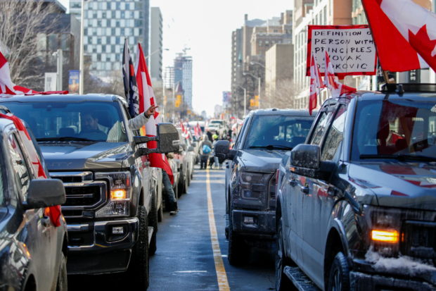Protestors occupy Bloor Street West as truckers and supporters continue to protest coronavirus disease (COVID-19) vaccine mandates, in Toronto, Ontario, Canada, February 5, 2022. REUTERS/Carlos Osorio