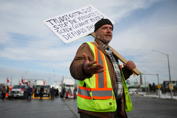 Photo of Canadian protester for story: Canadian authorities scramble to end protests vs. COVID measures