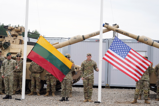 Photo of Lithuania and US flags for story: Lithuania seeks permanent US troop deployment in face of Russian build-up
