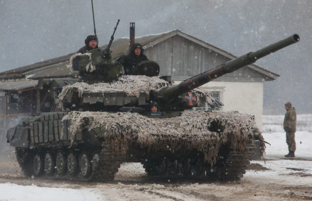 Service members of the Ukrainian Armed Forces drive a tank during military exercises in Kharkiv region, Ukraine February 10, 2022. REUTERS/Vyacheslav Madiyevskyy