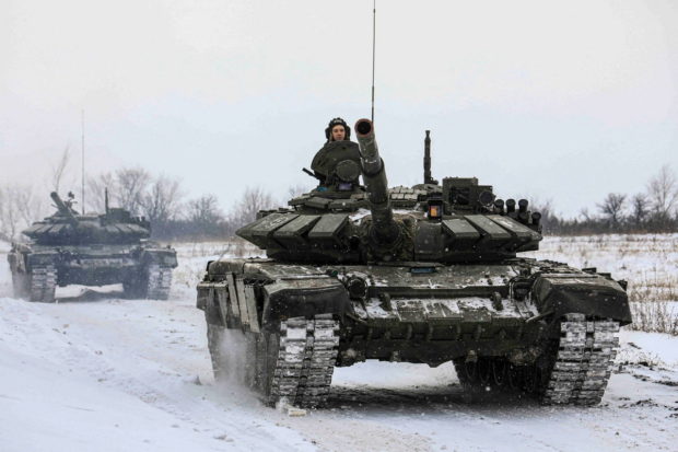 Russian servicemen drive tanks during military exercises in the Leningrad Region, Russia, in this handout picture released February 14, 2022. Russian Defence Ministry/Handout via REUTERS/File Photo