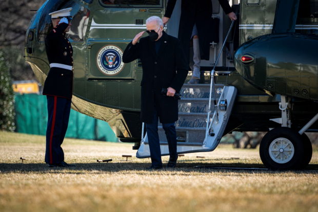 FILE PHOTO: U.S. President Joe Biden salutes a Marine as he arrives on Marine One on the South Lawn of the White House following a trip to Delaware, in Washington, D.C., U.S., February 6, 2022. REUTERS/Al Drago/File Photo