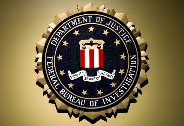 FILE PHOTO: The Federal Bureau of Investigation seal is seen at FBI headquarters before a news conference by FBI Director Christopher Wray on the U.S Justice Department's inspector general's report regarding the actions of the Federal Bureau of Investigation and the 2016 U.S. presidential election in Washington, U.S. June 14, 2018.    REUTERS/Yuri Gripas/File Photo