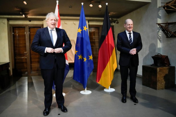 German Chancellor Olaf Scholz, and Britain's Prime Minister Boris Johnson pose for media prior to a meeting during the Munich Security Conference (MSC) in Munich, Germany February 19, 2022. Matt Dunham/Pool via REUTERS