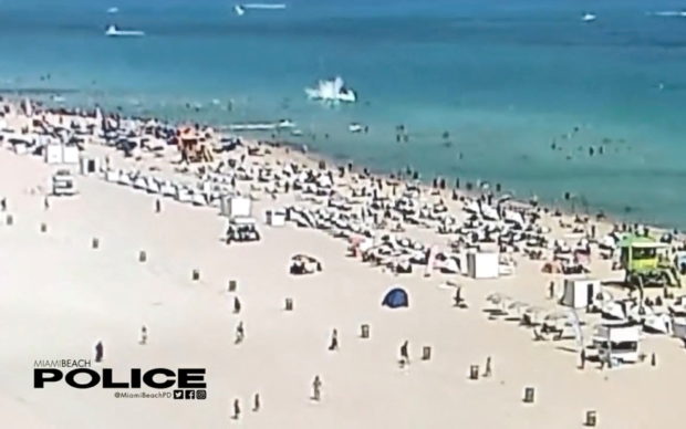 A view of a helicopter crashing into the ocean in Miami Beach, Miami, Florida, U.S., February 19, 2022, in this still image obtained from social media video.  Courtesy of Miami Beach Police Department/@MiamiBeachPD/via REUTERS