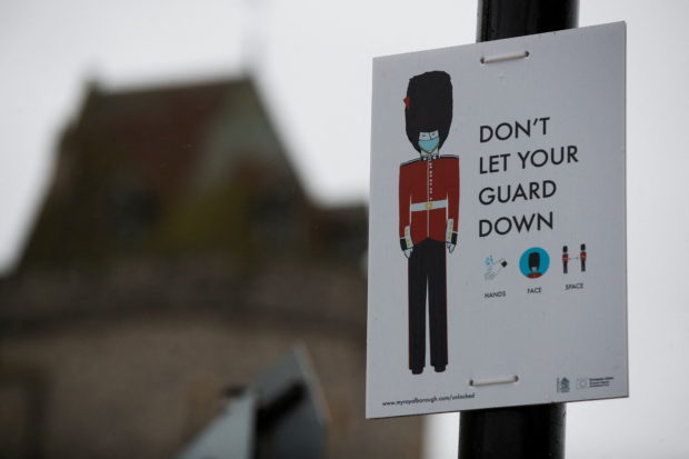 A sign on display outside Windsor Castle after it was announced that Britain's Queen Elizabeth tested positive for the coronavirus disease (COVID-19), in Windsor, Britain February 20, 2022. REUTERS/Peter Nicholls