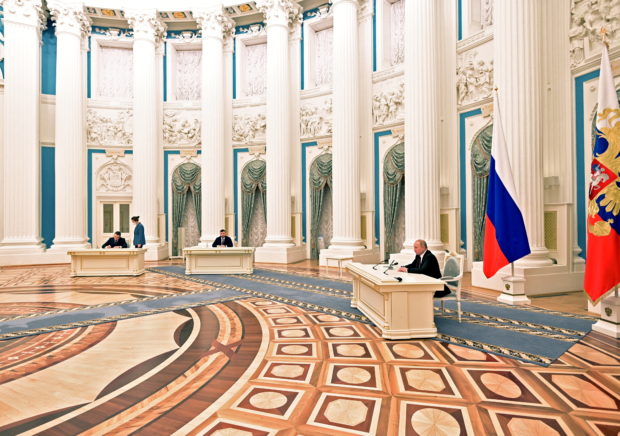 Russian President Vladimir Putin attends a ceremony to sign documents, including a decree recognising two Russian-backed breakaway regions in eastern Ukraine as independent entities, with leaders of the self-proclaimed republics Leonid Pasechnik and Denis Pushilin seen in the background, in Moscow, Russia, in this picture released February 21, 2022. Sputnik/Alexey Nikolsky/Kremlin via REUTERS