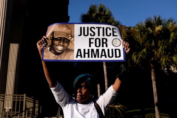 A woman holds a sign outside a US court