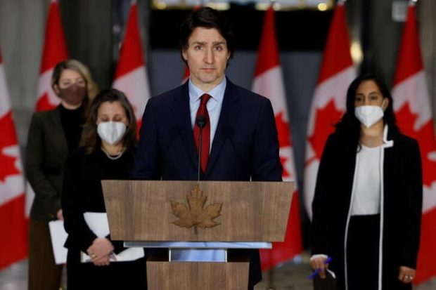FILE PHOTO: Canada's Prime Minister Justin Trudeau, with Minister of Foreign Affairs Melanie Joly, Deputy Prime Minister and Minister of Finance Chrystia Freeland, and Minister of National Defence Anita Anand, attends a news conference in Ottawa, Ontario, Canada February 24, 2022. REUTERS/Blair Gable