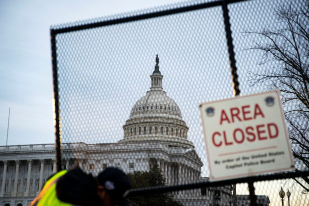 The U.S. Capitol, seen behind newly installed security fencing ahead of the upcoming State of the Union with U.S. President Joe Biden, in Washington, U.S., February 27, 2022. REUTERS/Al Drago