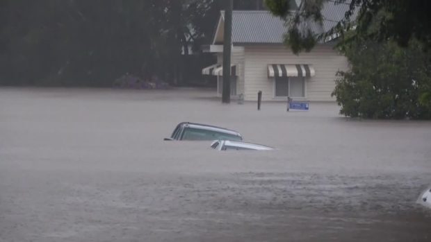 People flee to rooftops as 'weather bomb' submerges Australian towns
