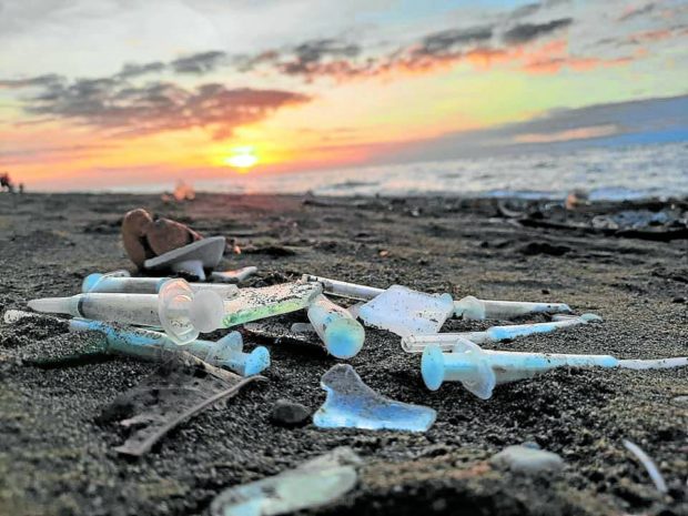 Use syringes and other medical waste on a beach in Toledo City, for story: Cebu City execs seek report on medical waste disposal