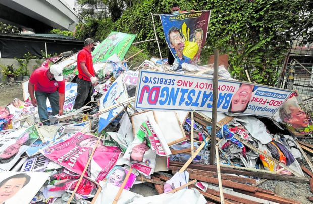 MMDA workers with taken down campaign materials, FOR STORY: SC asked to stop ‘Oplan Baklas’ on private property