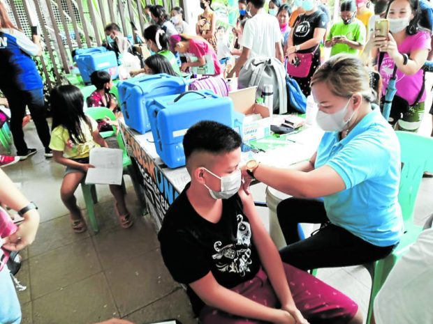 Kids get vaccinated at a resort in Pandi, Bulacan, for story: Bulacan kids treated to resort swim before vaccination