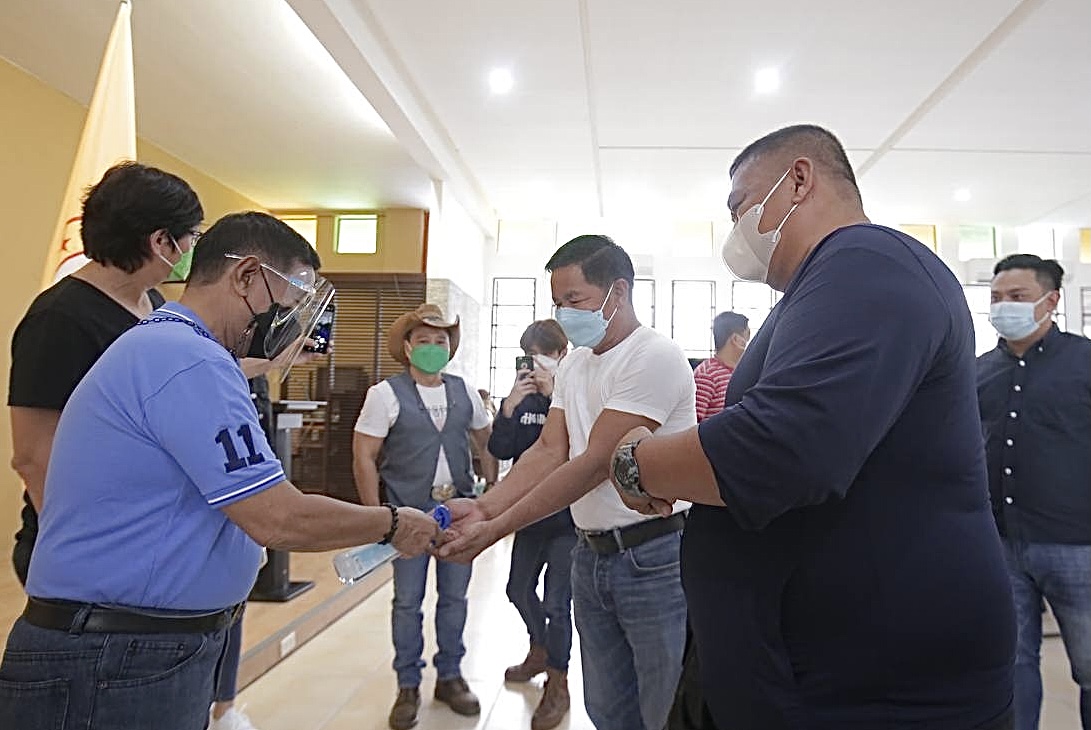 Senatorial candidate and former Vice President Jejomar Binay sprays alcohol on the hands of a supporter in Batangas City, Batangas as he launches his senatorial campaign. elections PHOTO FROM Makati PIO 