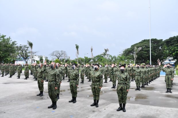 Recruits take their oath of office at Police Regional Office 3 (PRO3) Parade Ground inside Camp Olivas in the City of San Fernando, Pampanga province in this photo taken July 2021