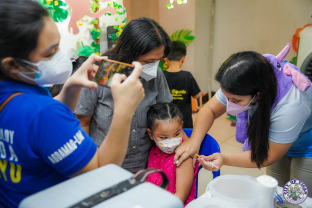Child gets COVID-19 vaccination in Vigan, for story: More than 63 million Filipinos now fully vaccinated – Galvez