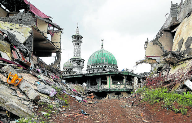 Marawi damaged structures. STORY: The bullet-ridden Mindanao Islamic Center (balcony photo), in a photo taken in 2017, stands amid ruined structures following the five-month war between government troops and Islamic State-linked terrorists in Marawi City. —JEOFFREY MAITEM 