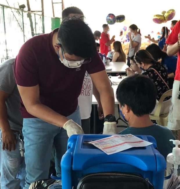 A kid with special needs gets vaccinated against COVID-19 in Angeles City