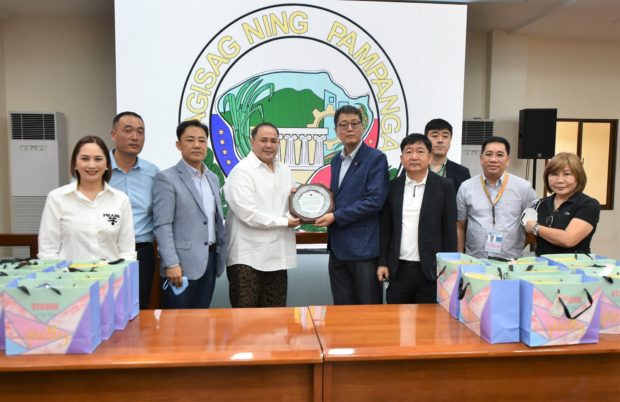 Pampanga Gov. Dennis Pineda receives a plaque of appreciation from president Lee Chang Ho of the Korean Community Association in Central Luzon