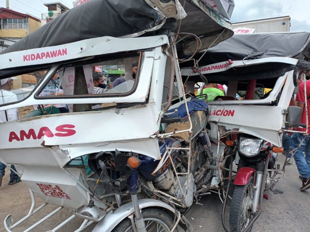 A forward van loaded with canned goods plows on Monday tricycles in a busy stretch of Kidapawan City highway
