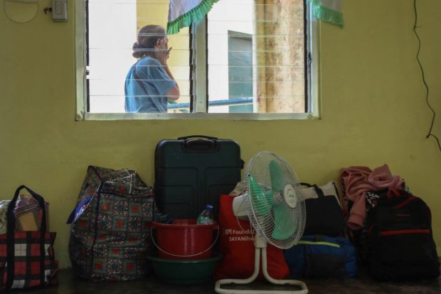 Belongings of residents living near Taal volcano are seen in a room after they evacuated to a public school in Laurel, Batangas, on March 26, 2022, after an eruption earlier in the morning sent ash and steam hundreds of metres into the sky. STORY: 2,000 evacuees affected by Taal activity