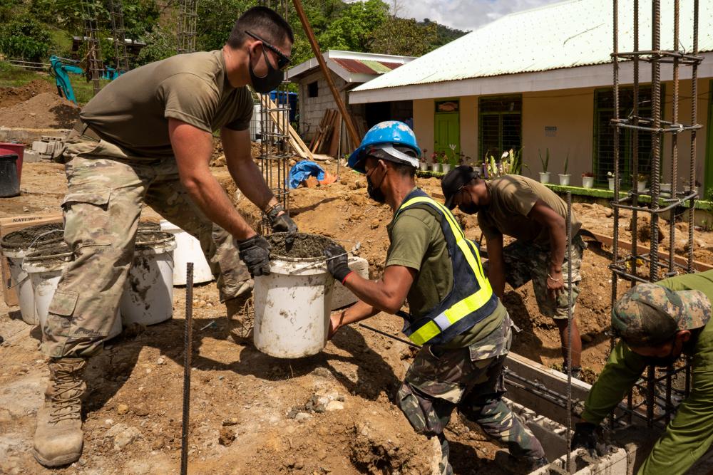 Members of the Armed Forces of the Philippines and U.S. Air Force 18th Civil Engineer Group, 18th Wing, work together on construction efforts ahead of Balikatan 22 at Masi Elementary School, Rizal, Cagayan. 