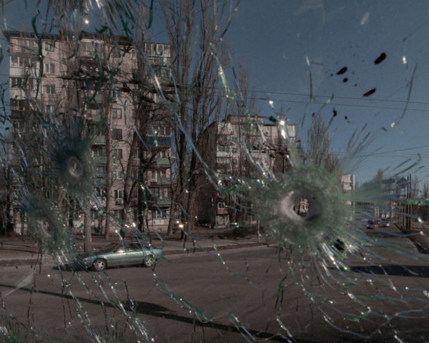 Cars are seen through the damaged window of a vehicle hit by bullets, as Russia's invasion of Ukraine continues, in Kyiv, Ukraine February 28, 2022. Jedrzej Nowicki/Agencja Wyborcza.pl via REUTERS